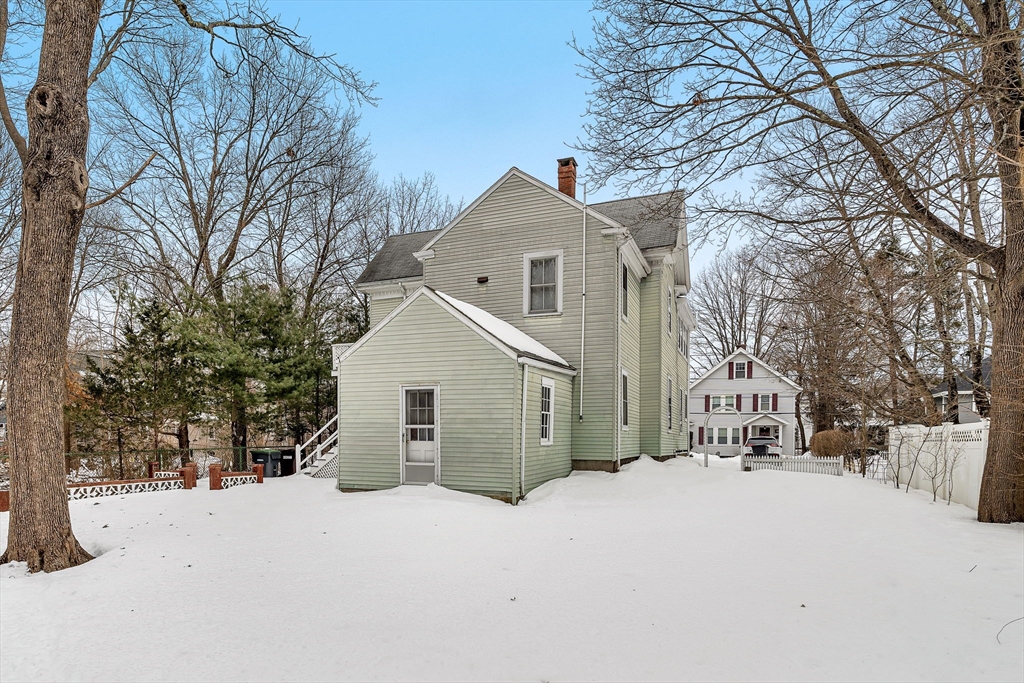 28 Linden Place Dedham, MA 02026 - Photo 3 of 42 a view of a house with a yard covered in snow