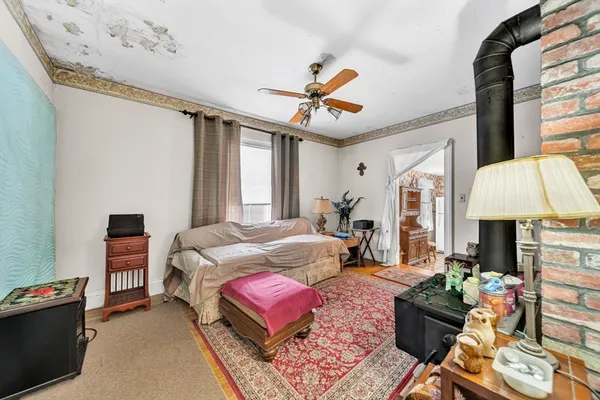 a bedroom with a bed couch and window