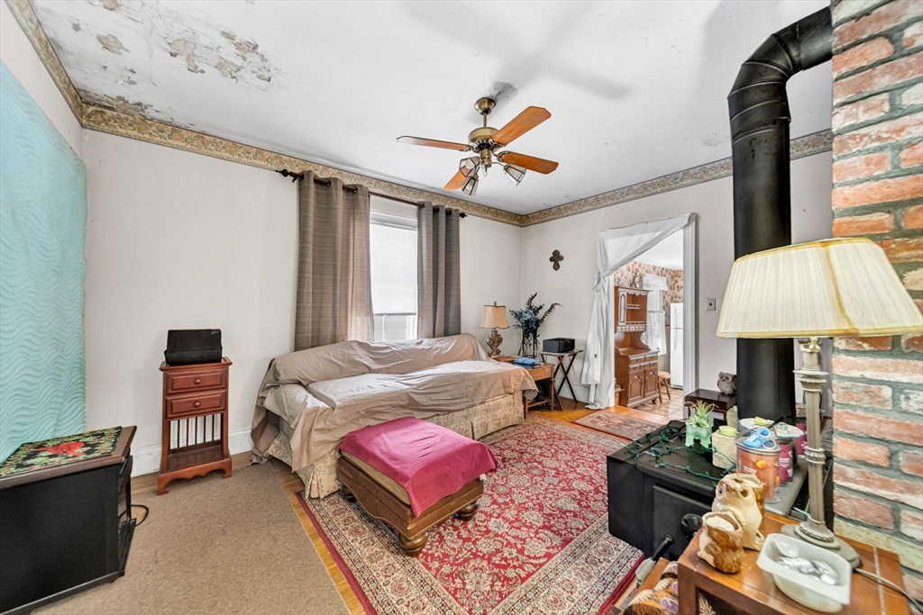 28 Linden Place Dedham, MA 02026 - Photo 32 of 42 a bedroom with a bed couch and window