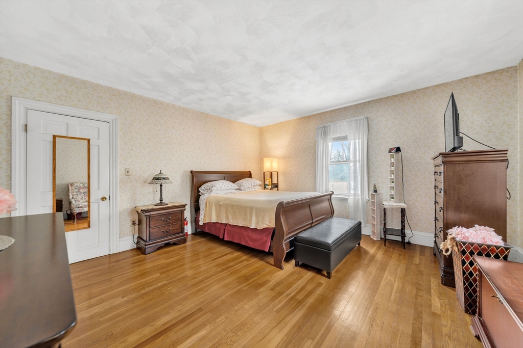 28 Linden Place Dedham, MA 02026 - Photo 34 of 42 a bedroom with a bed and wooden floor