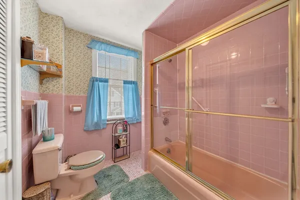 a bathroom with a toilet and shower
