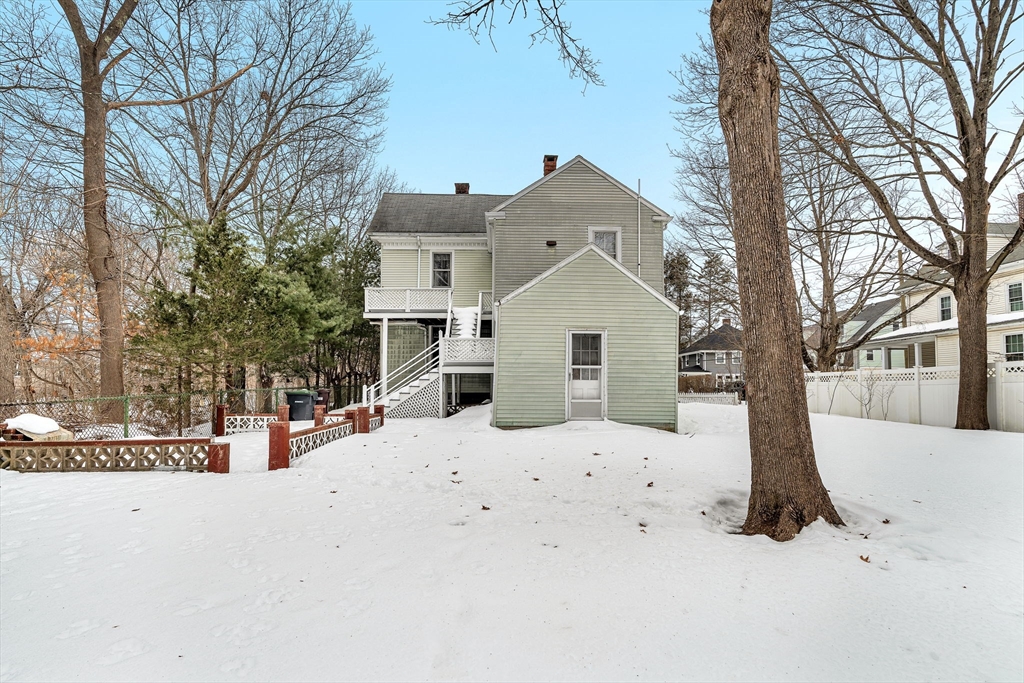 28 Linden Place Dedham, MA 02026 - Photo 4 of 42 a view of white house with a yard covered in snow