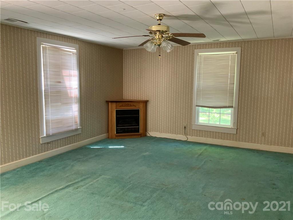 2149 Smithford Road Hickory Grove, SC 29717 - Photo 10 of 16 an empty room with windows and fireplace