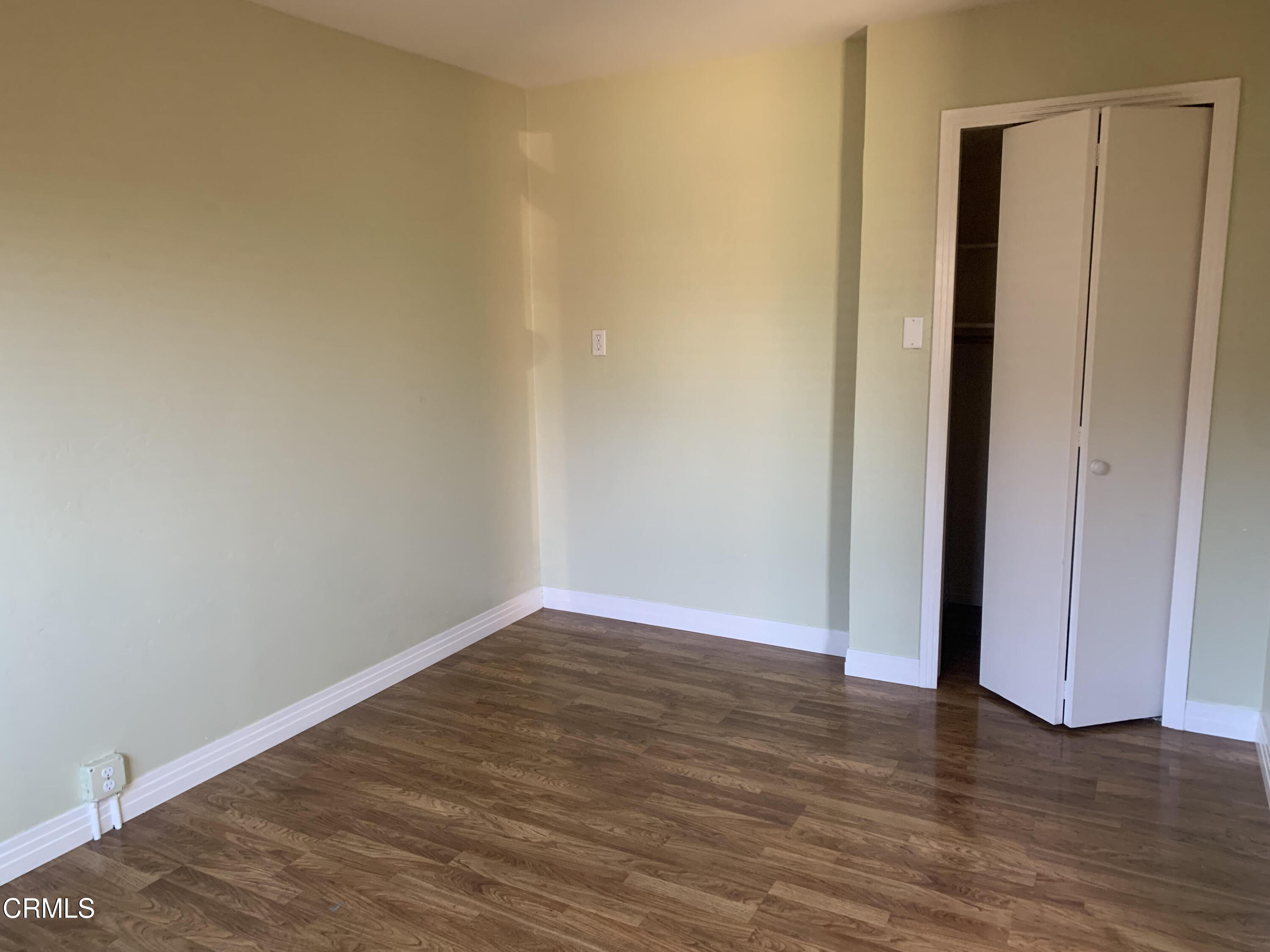 141 Burbank Avenue Oxnard, CA 93035 - Photo 5 of 8 a view of an empty room with wooden floor and closet