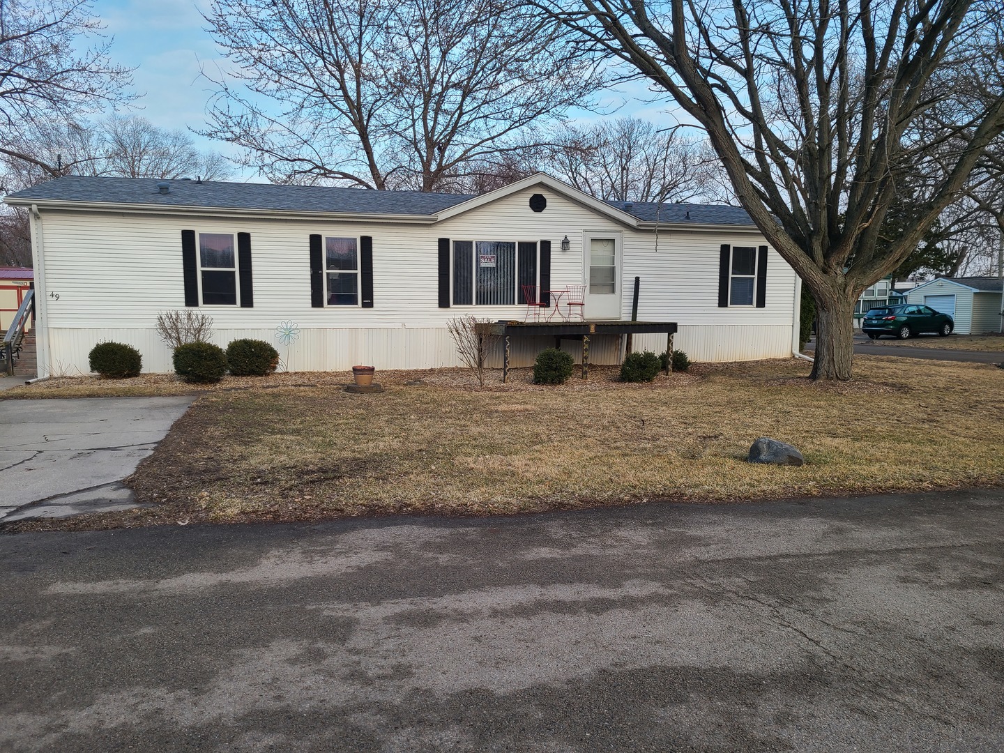 291 Highway 2, Unit 49 Dixon, IL 61021 - Photo 1 of 28 a view of a white house with a yard in front of it