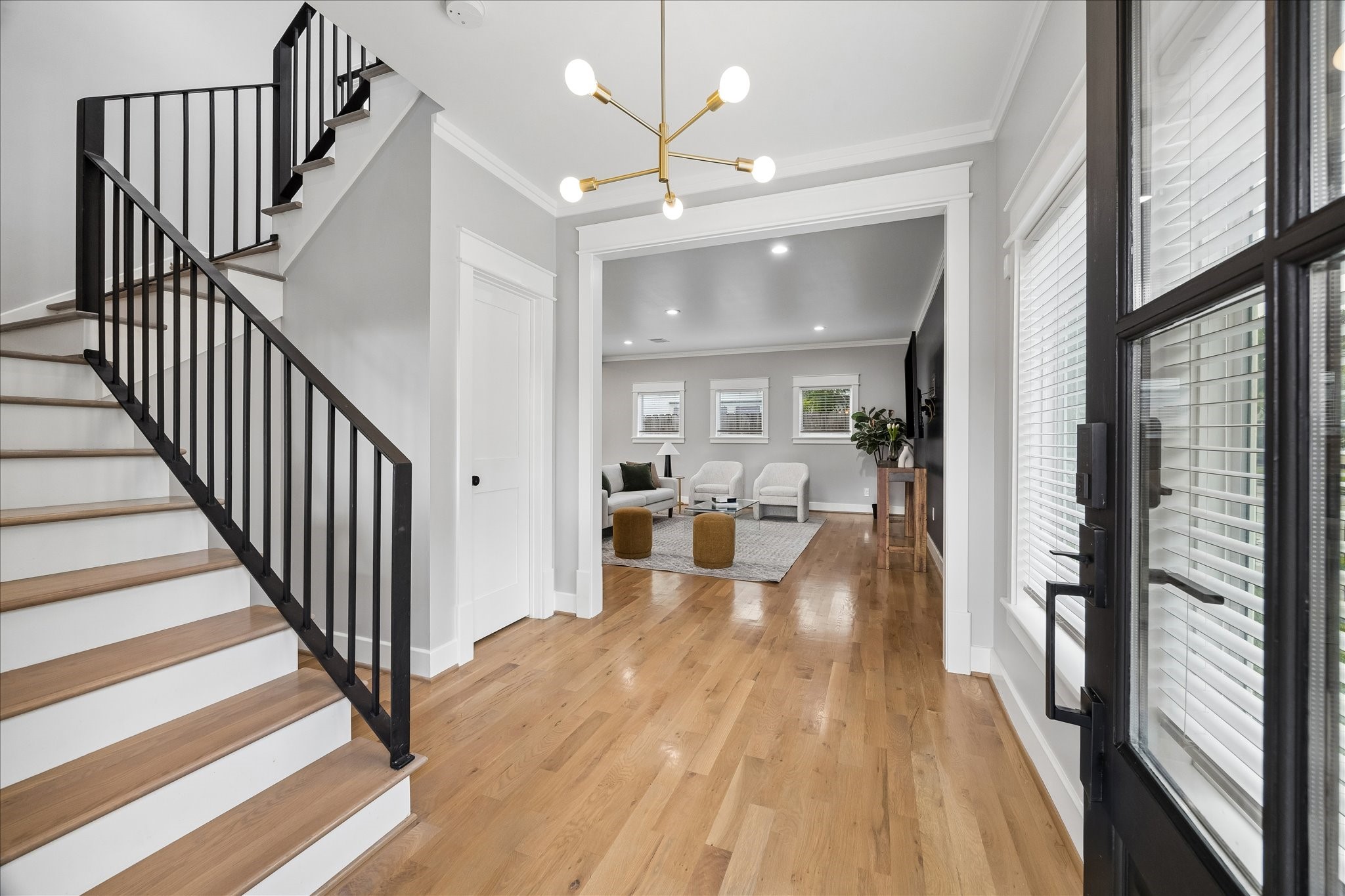 1205 Temple Street Houston, TX 77009 - Photo 9 of 33 Natural light, warm wood floors, and clean architectural lines create an immediate sense of openness, offering a sophisticated welcome that carries throughout the home.