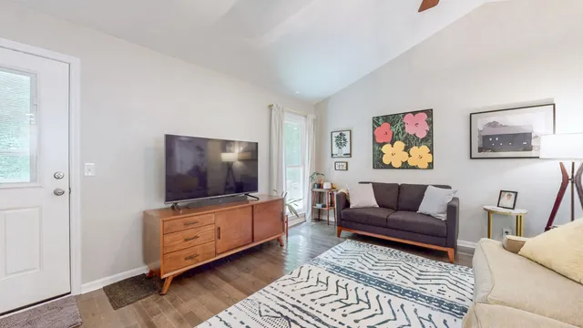 a living room with furniture and a flat screen tv