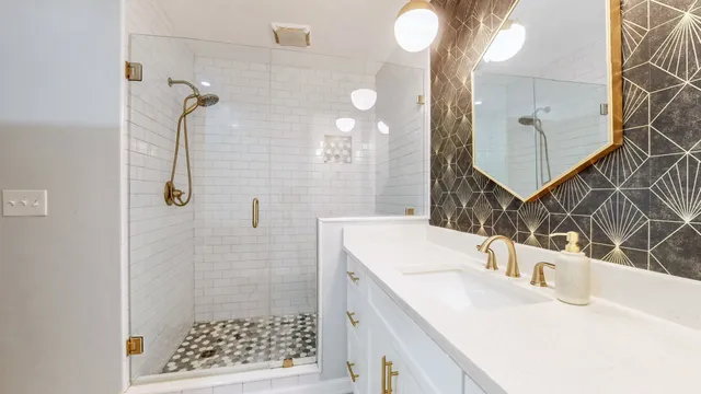 a bathroom with a sink vanity and shower