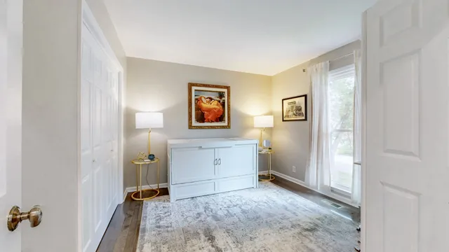 a view of a bedroom with bed and hallway
