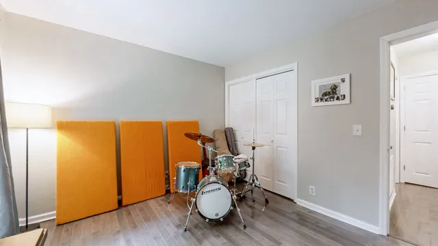 a view of a room with wooden floor lounge chair and windows