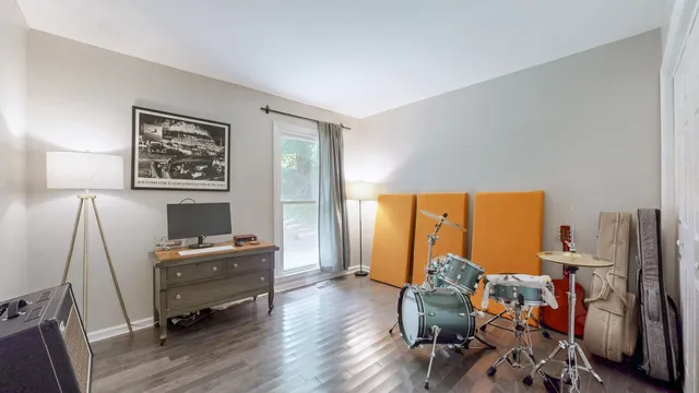 a view of a workspace with furniture and a window