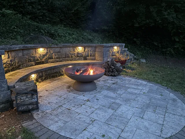 a backyard of a house with yard fire pit and outdoor seating