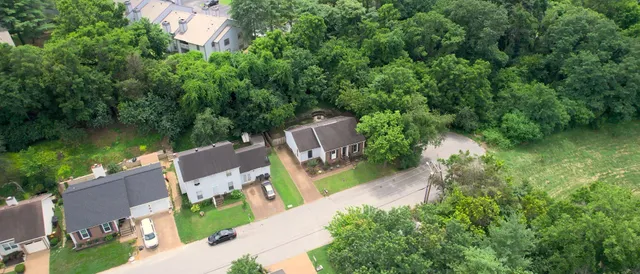 an aerial view of a house with a yard and lake view