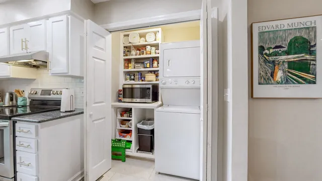 a kitchen with stainless steel appliances a refrigerator and a window