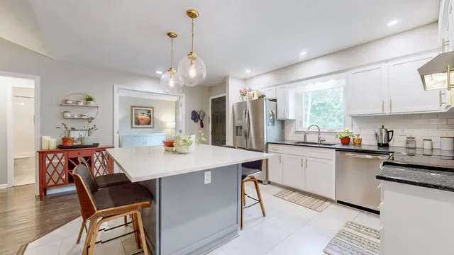 a large kitchen with a table and chairs