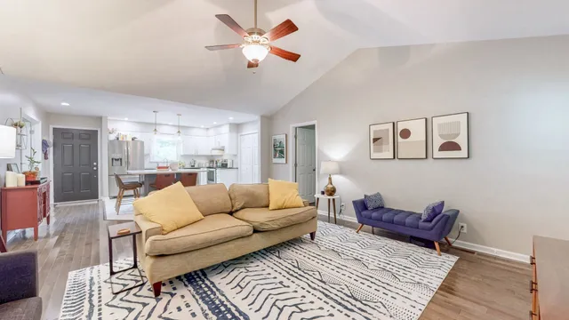 a living room with furniture and a chandelier