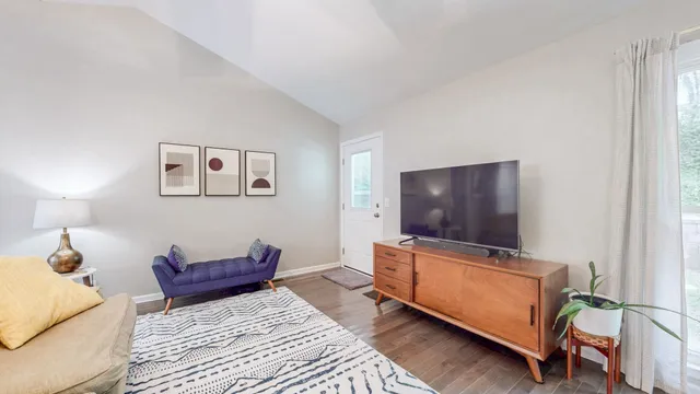 a living room with furniture and a flat screen tv
