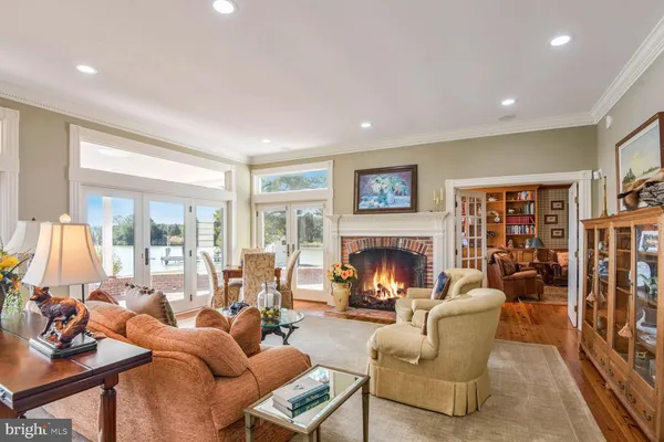 a living room filled with furniture and large windows
