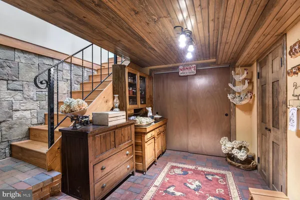 a living room with furniture a rug and a flat screen tv
