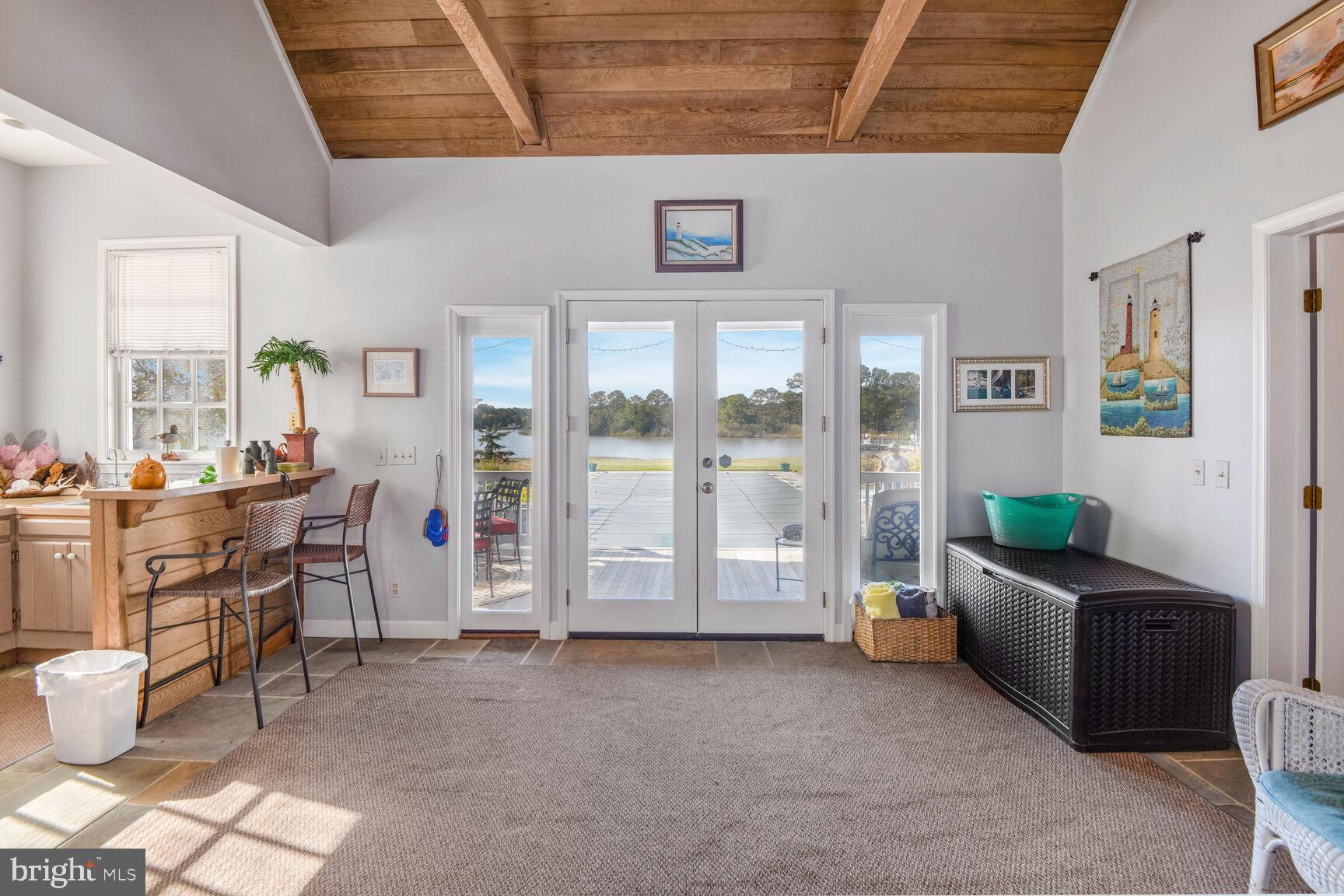 5289 Ferry Neck Road Royal Oak, MD 21662 - Photo 46 of 80 a living room with furniture and a floor to ceiling window