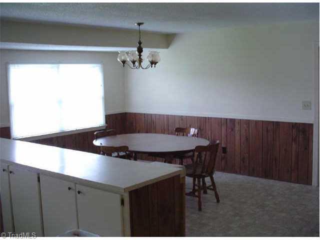 1192 Dodson Mill Road Pilot Mountain, NC 27041 - Photo 5 of 9 Other. Dining room has large windows and is separated from kitchen by bar.
