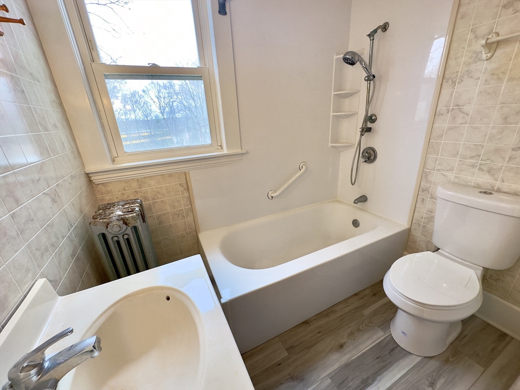 56 South Main Street Uxbridge, MA 01569 - Photo 14 of 14 a bathroom with a sink a toilet and a bathtub