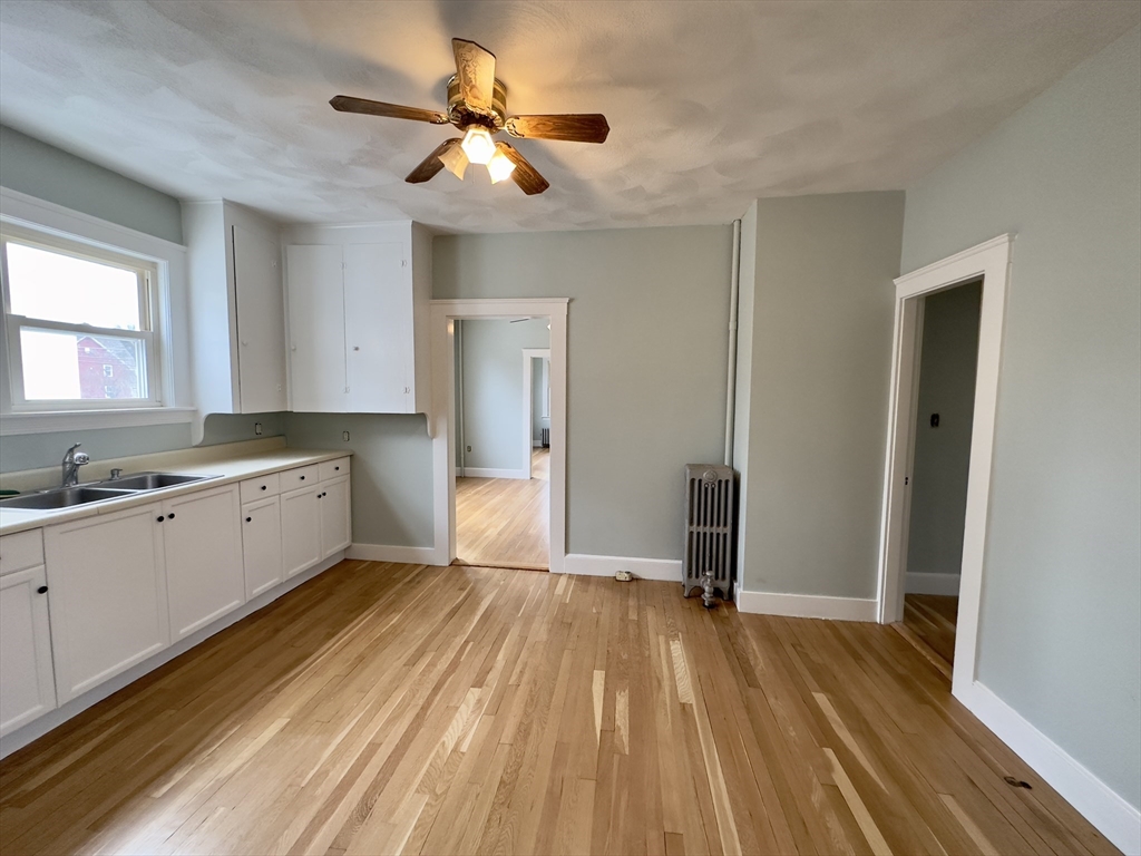 56 South Main Street Uxbridge, MA 01569 - Photo 2 of 14 a view of a kitchen with wooden floor and a sink