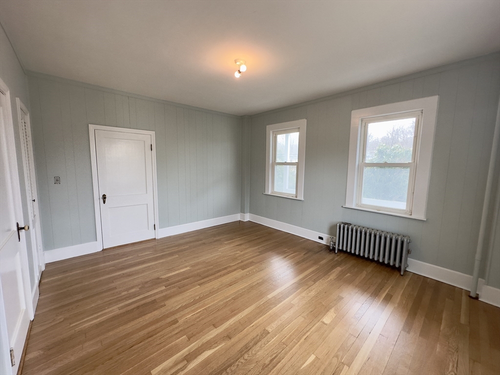 56 South Main Street Uxbridge, MA 01569 - Photo 3 of 14 a view of an empty room with wooden floor and a window