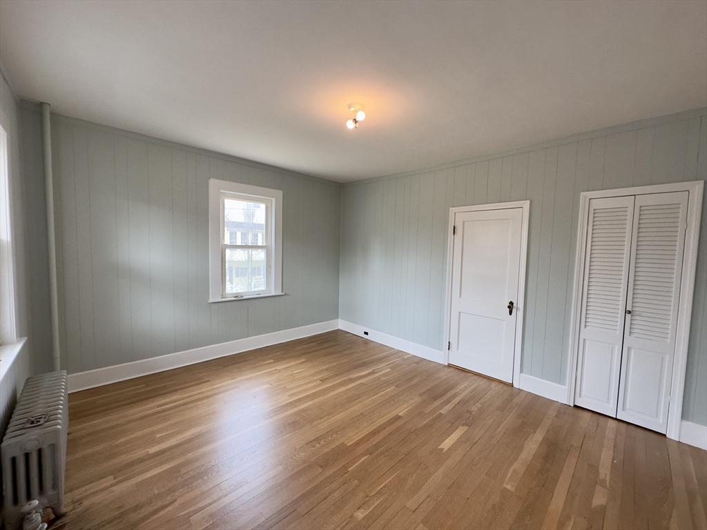 56 South Main Street Uxbridge, MA 01569 - Photo 4 of 14 a view of empty room with wooden floor and fan