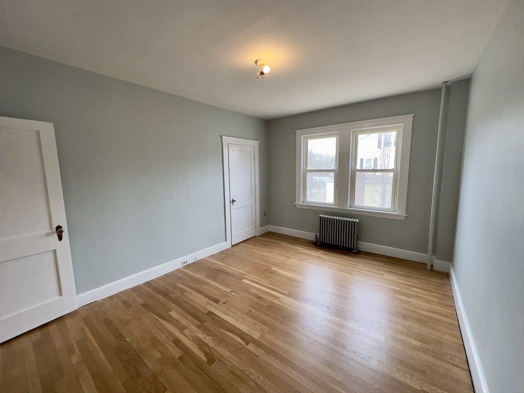 56 South Main Street Uxbridge, MA 01569 - Photo 5 of 14 a view of empty room with window and wooden floor