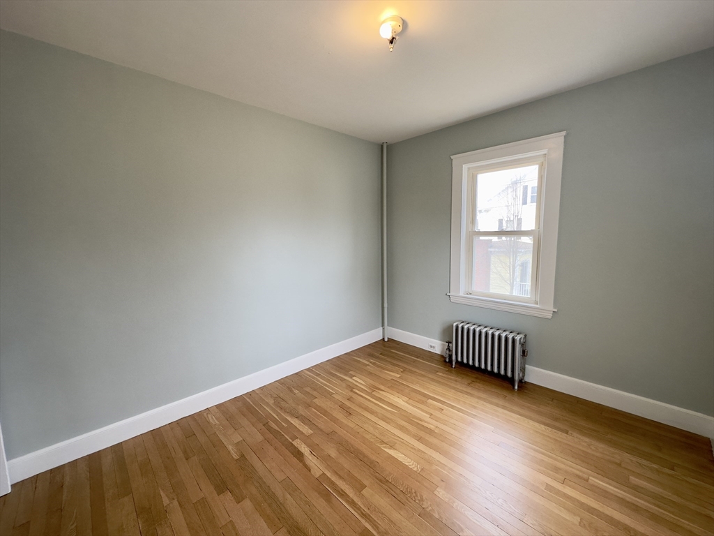 56 South Main Street Uxbridge, MA 01569 - Photo 7 of 14 wooden floor in an empty room with a window