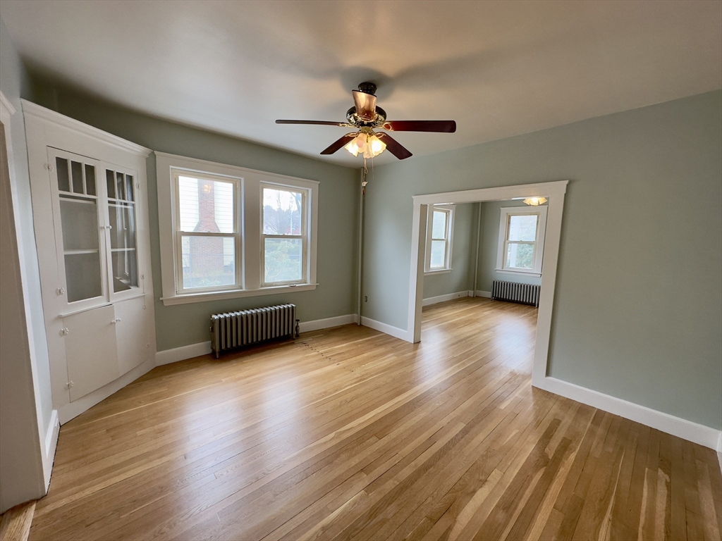 56 South Main Street Uxbridge, MA 01569 - Photo 9 of 14 a view of empty room with wooden floor and fan