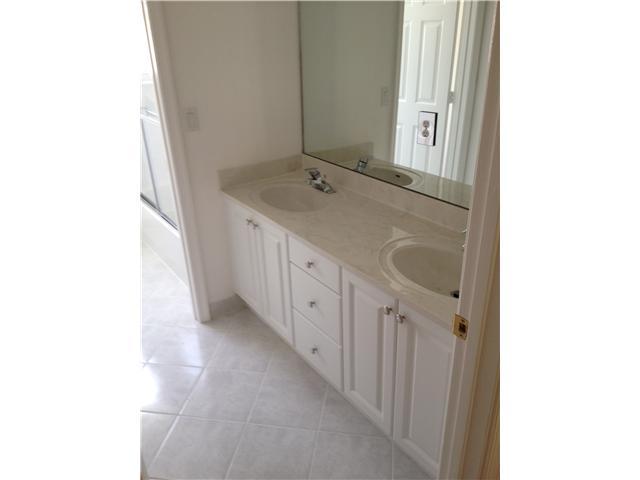 2023 Reston Circle Royal Palm Beach, FL 33411 - Photo 15 of 23 a bathroom with a double vanity sink and mirror