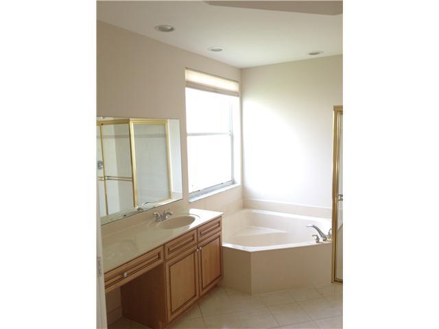 2023 Reston Circle Royal Palm Beach, FL 33411 - Photo 18 of 23 a bathroom with a tub and a sink
