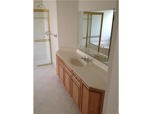 2023 Reston Circle Royal Palm Beach, FL 33411 - Photo 20 of 23 a bathroom with a sink a mirror and a bathtub