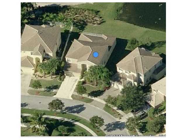 2023 Reston Circle Royal Palm Beach, FL 33411 - Photo 8 of 23 an aerial view of a house with a yard and lake view