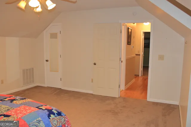 wooden floor in a bedroom next to a window