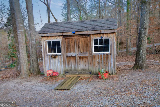 a backyard of a house with barbeque oven