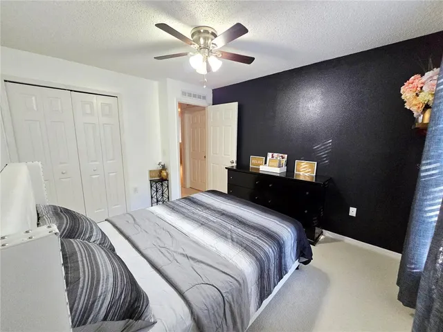 a bedroom with a bed and a tv