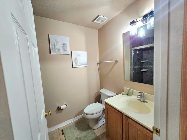 a bathroom with a sink a toilet and mirror