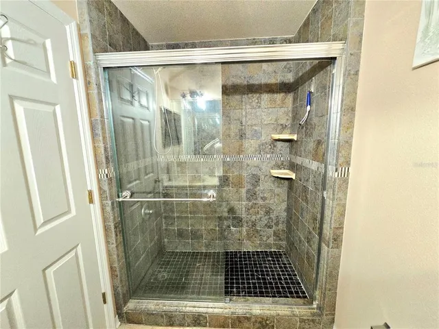 a bathroom with a glass door shower