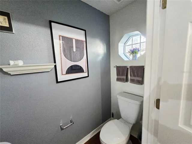 a white toilet sitting next to a bathroom sink