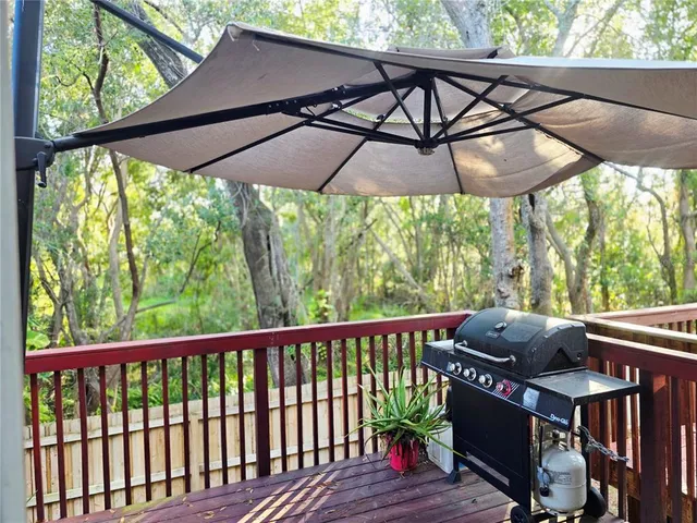 a view of balcony with wooden floor and outdoor seating