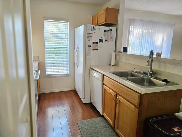 a kitchen with a sink stove and refrigerator