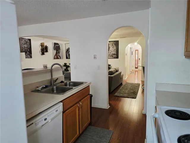 a hallway with a sink and cabinets