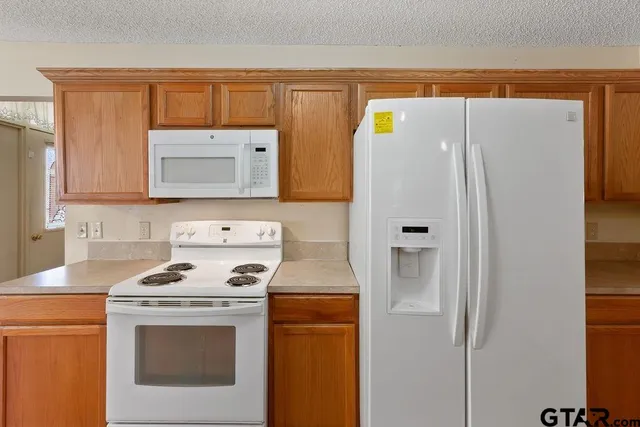 a kitchen with a stove cabinets and refrigerator