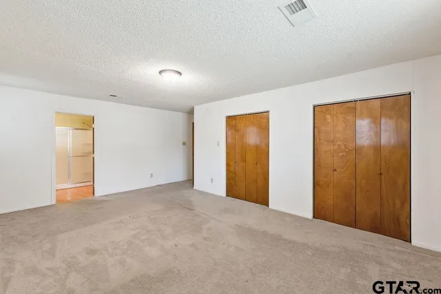 a view of an empty room and a window