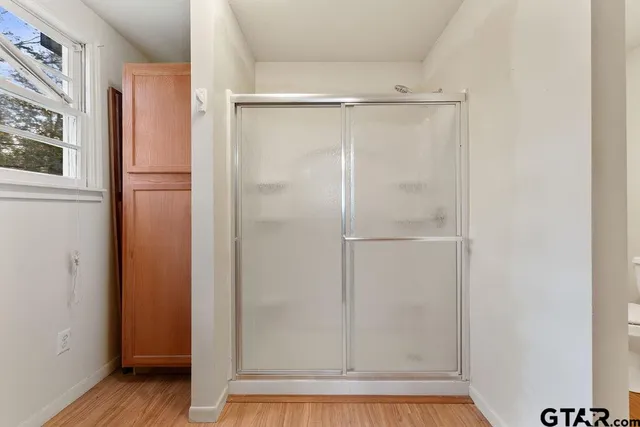 a bathroom with a glass shower door