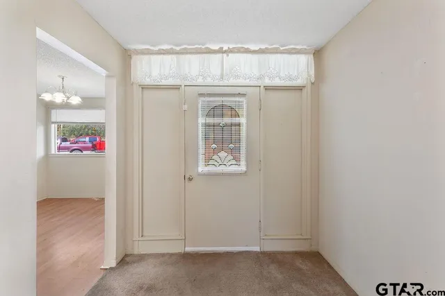 a view of entryway with kitchen