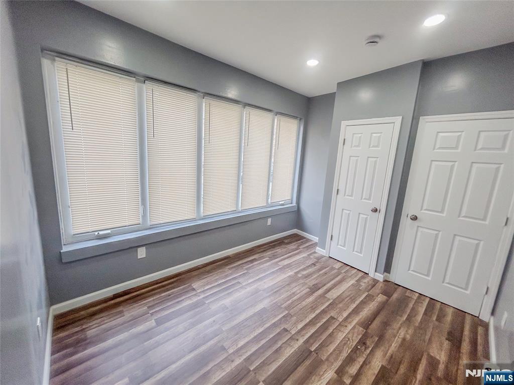 676 South 20th Street Newark, NJ 07103 - Photo 16 of 38 a view of an empty room with wooden floor and a window